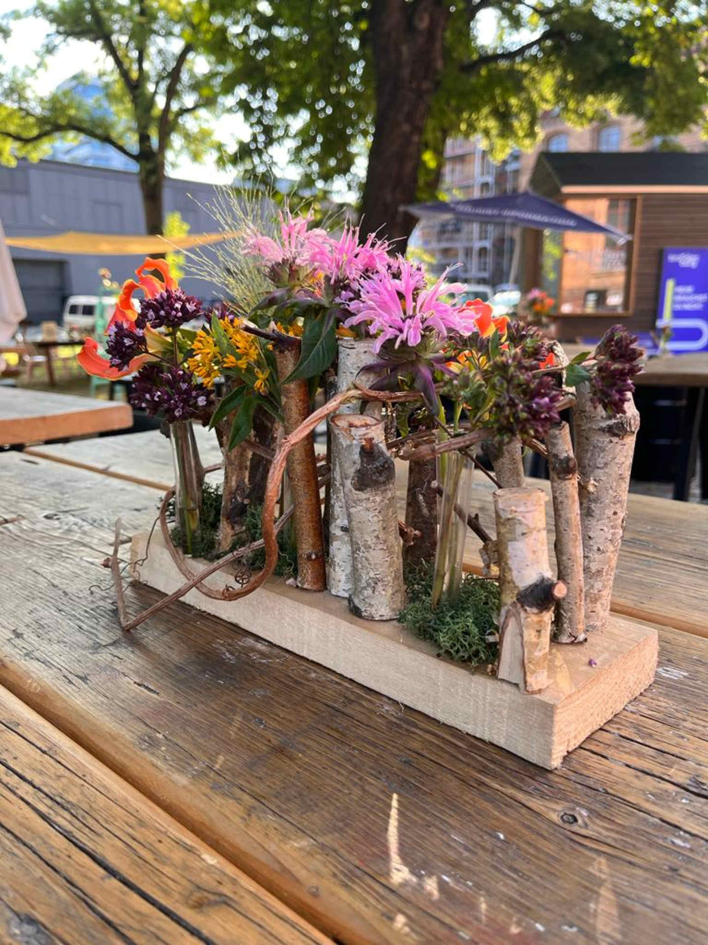 Außenbereich mit Holztisch und Blumendekoration mit Naturelementen